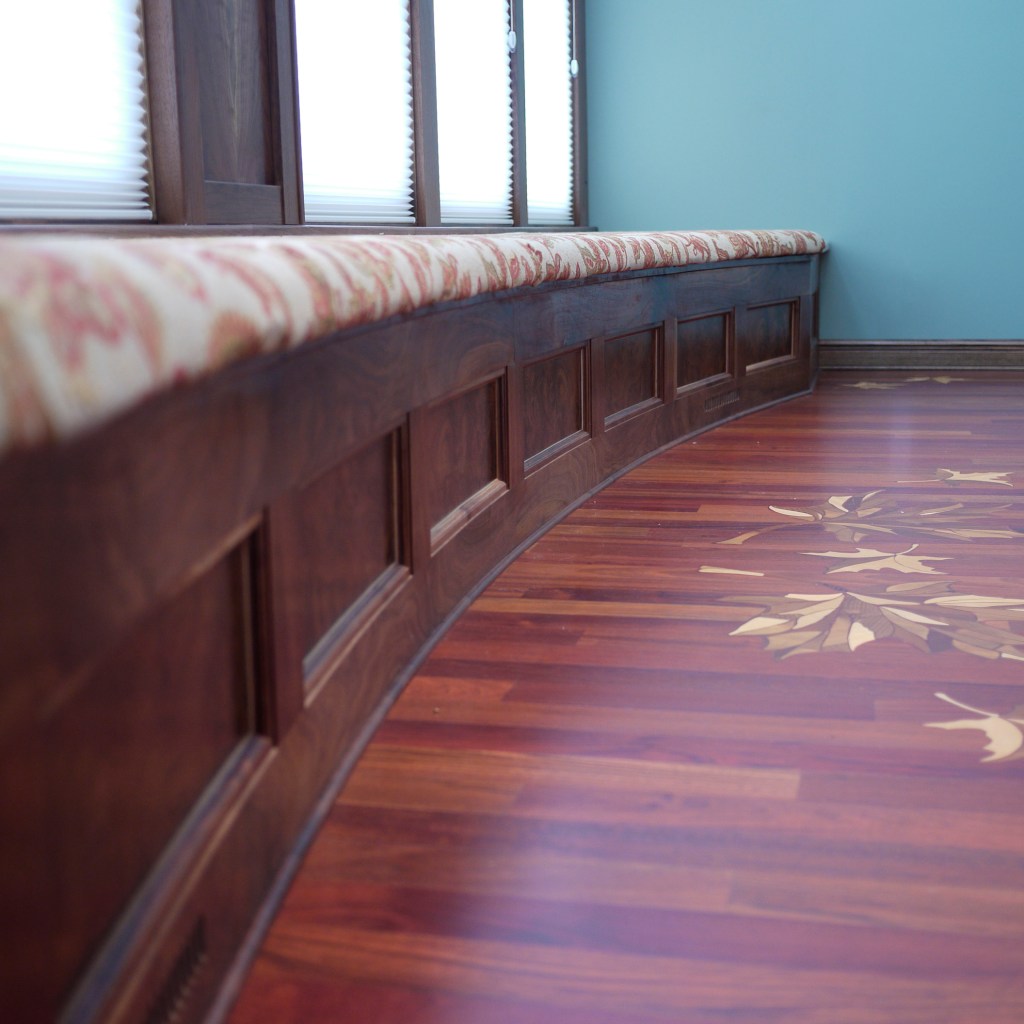 walnut built in curved bench with inlayed oak leaves