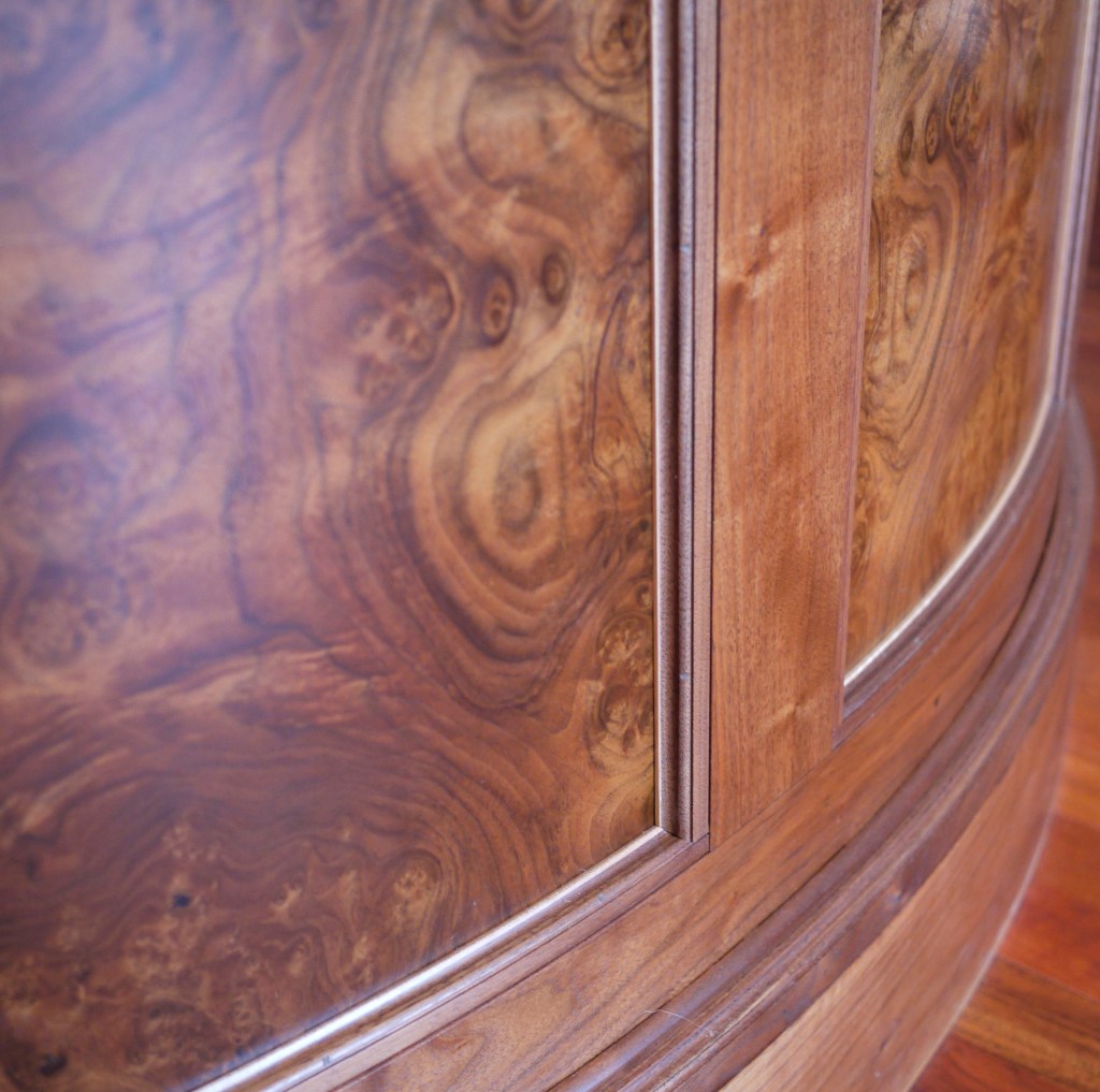 intense walnut burl veneer on curved bar front with maple accent trim