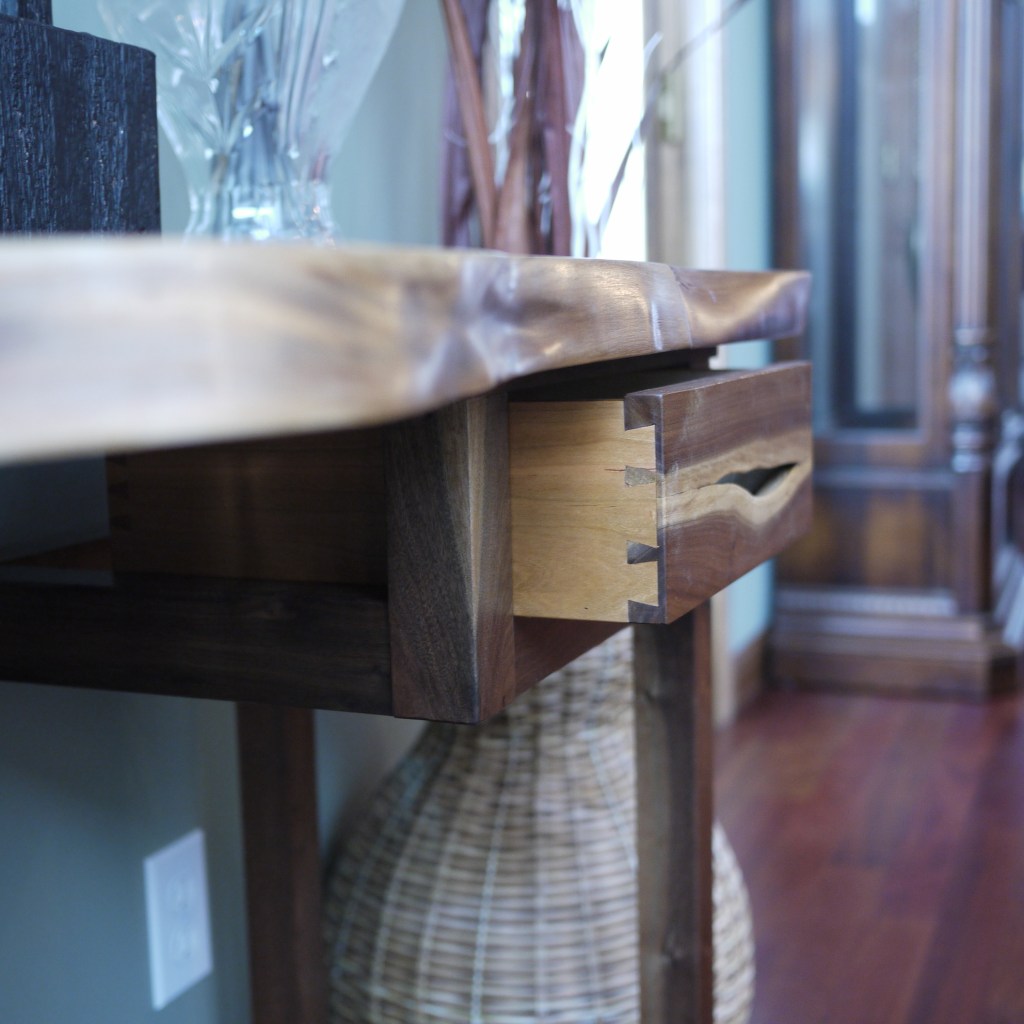 Side view of hall table with live edge handled drawer and half blind dovetail drawer sides