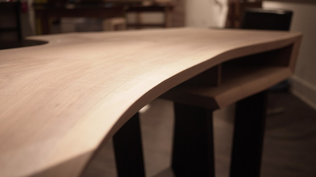 walnut live edge urban loft desk with drawer space and blurred background