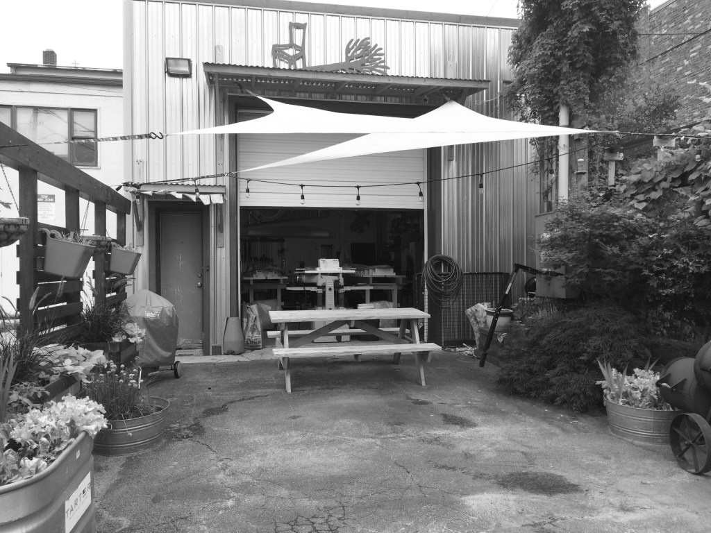 Urban Wood shop surrounded by urban garden with a picnic table